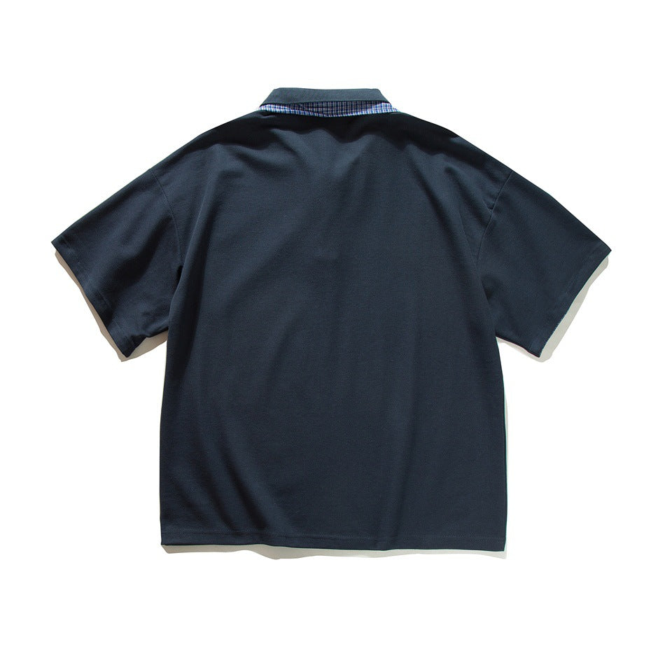 Back view of a navy short-sleeve polo shirt with plaid trim visible along the collar.