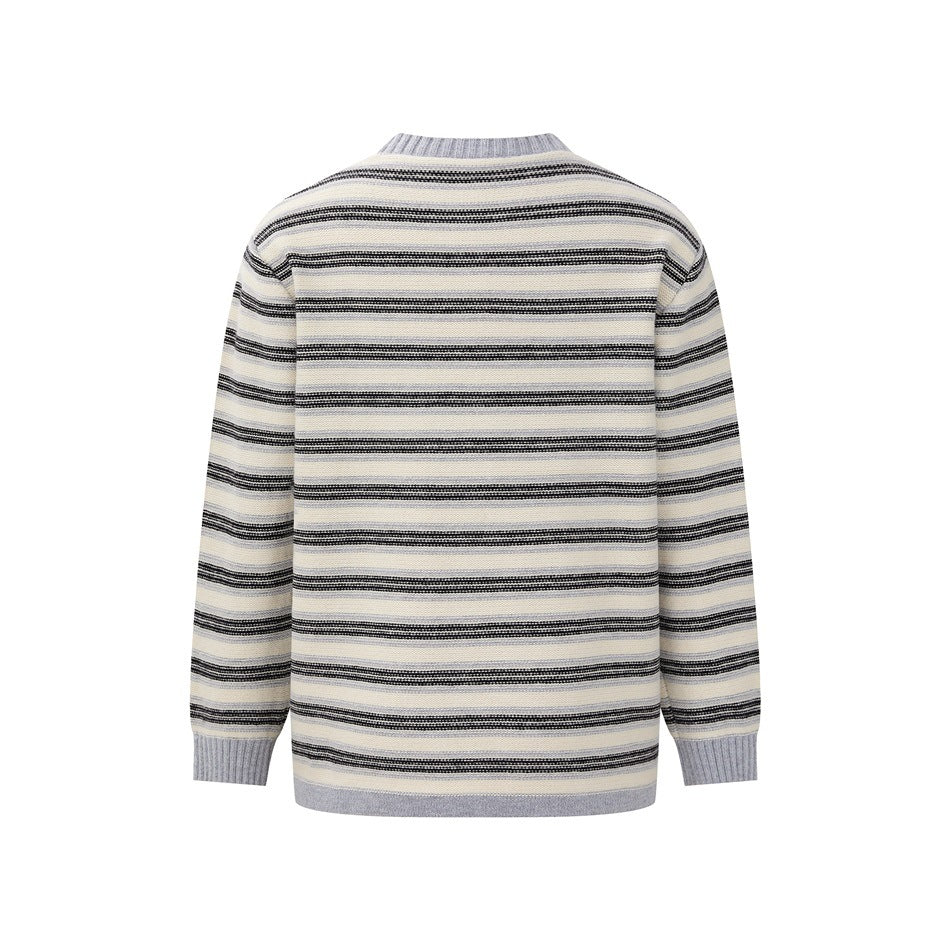 Back view of a long-sleeved cream sweater with horizontal black and gray stripes and gray ribbed trim.