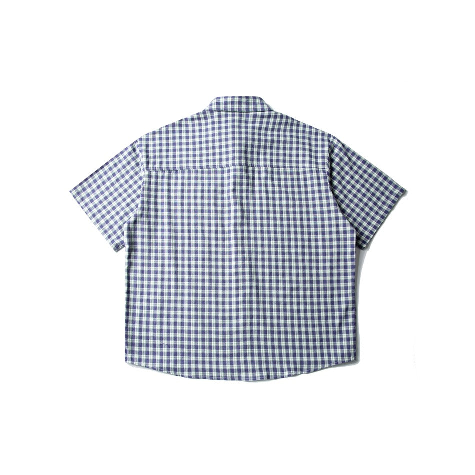 Back view of blue and white plaid short-sleeve shirt showing yoke seam, flat lay