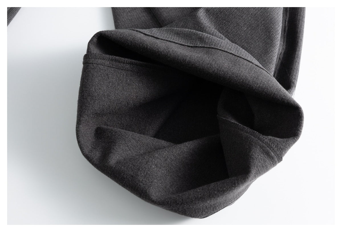Close-up of a charcoal gray trouser leg folded back to show the hem and darker interior.