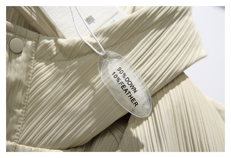 Close-up of a cream quilted garment with a hangtag reading “90% down, 10% feather.”
