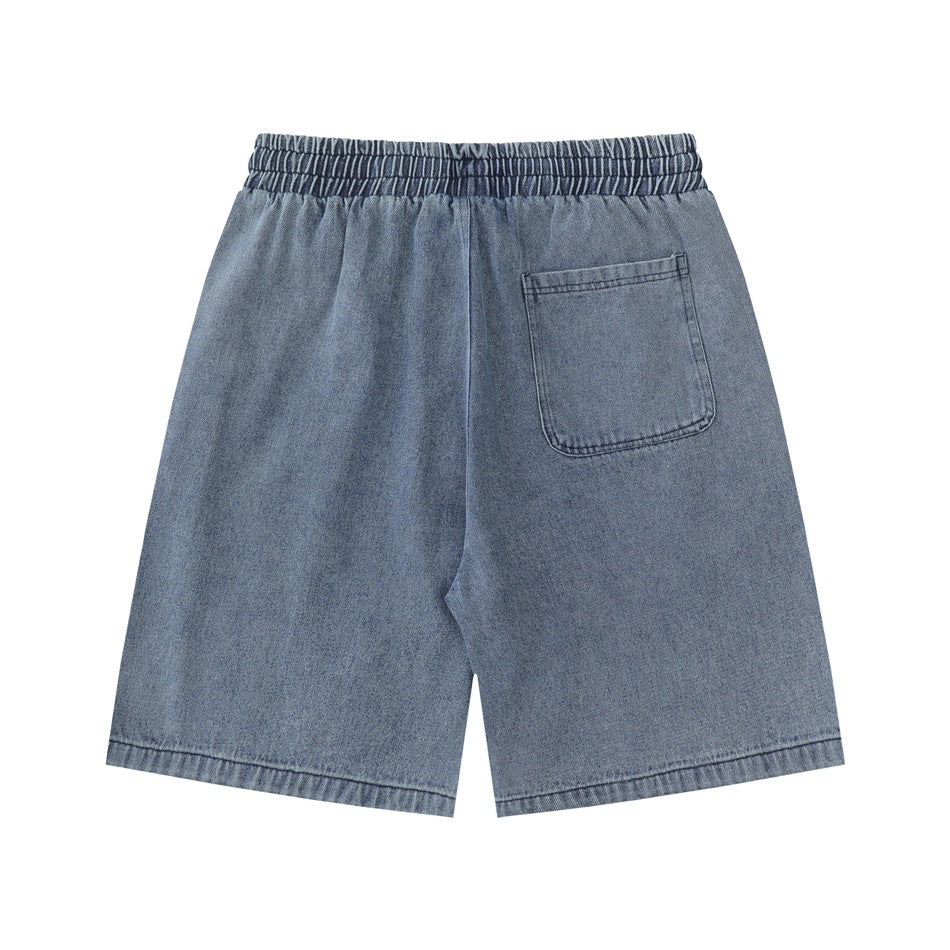 Back view of washed blue denim shorts with elastic waistband and a single patch pocket
