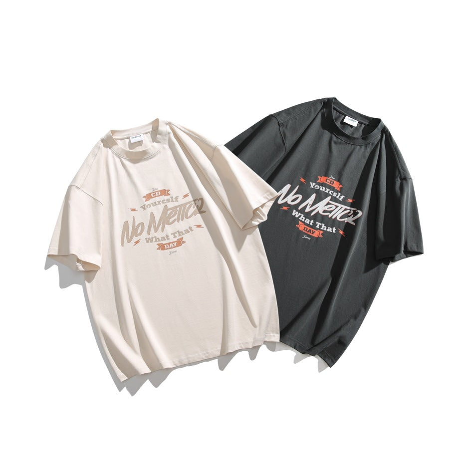 Off-white and charcoal gray oversized graphic T-shirts arranged together, front designs visible.