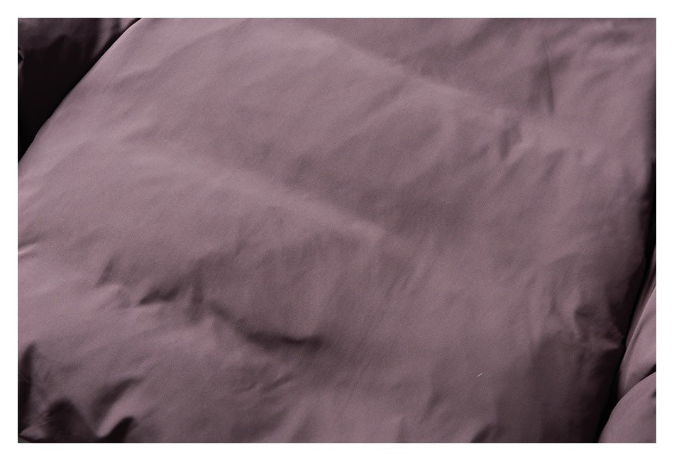 Close-up of wrinkled mauve fabric with soft folds.