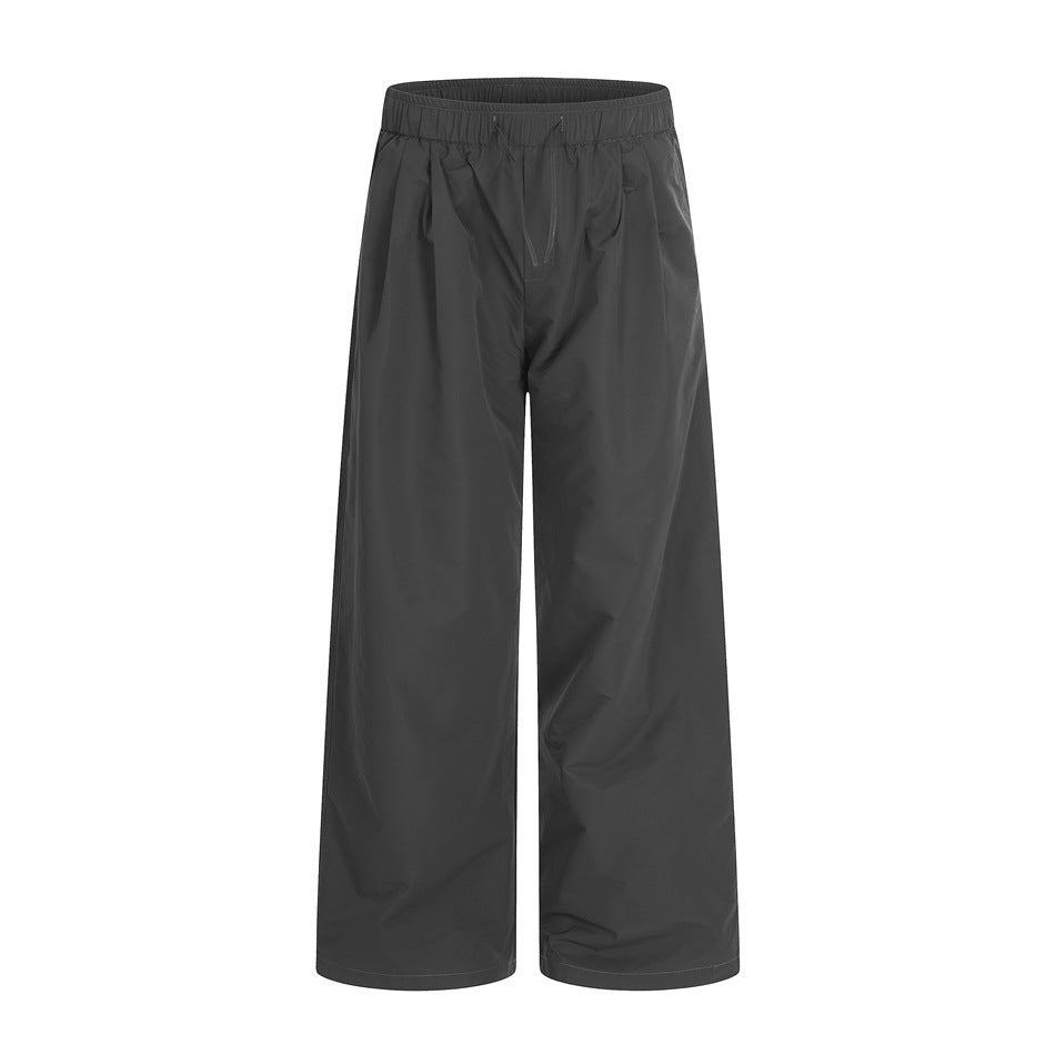 Dark gray wide-leg pants with elastic drawstring waist and front pleats, front flat view
