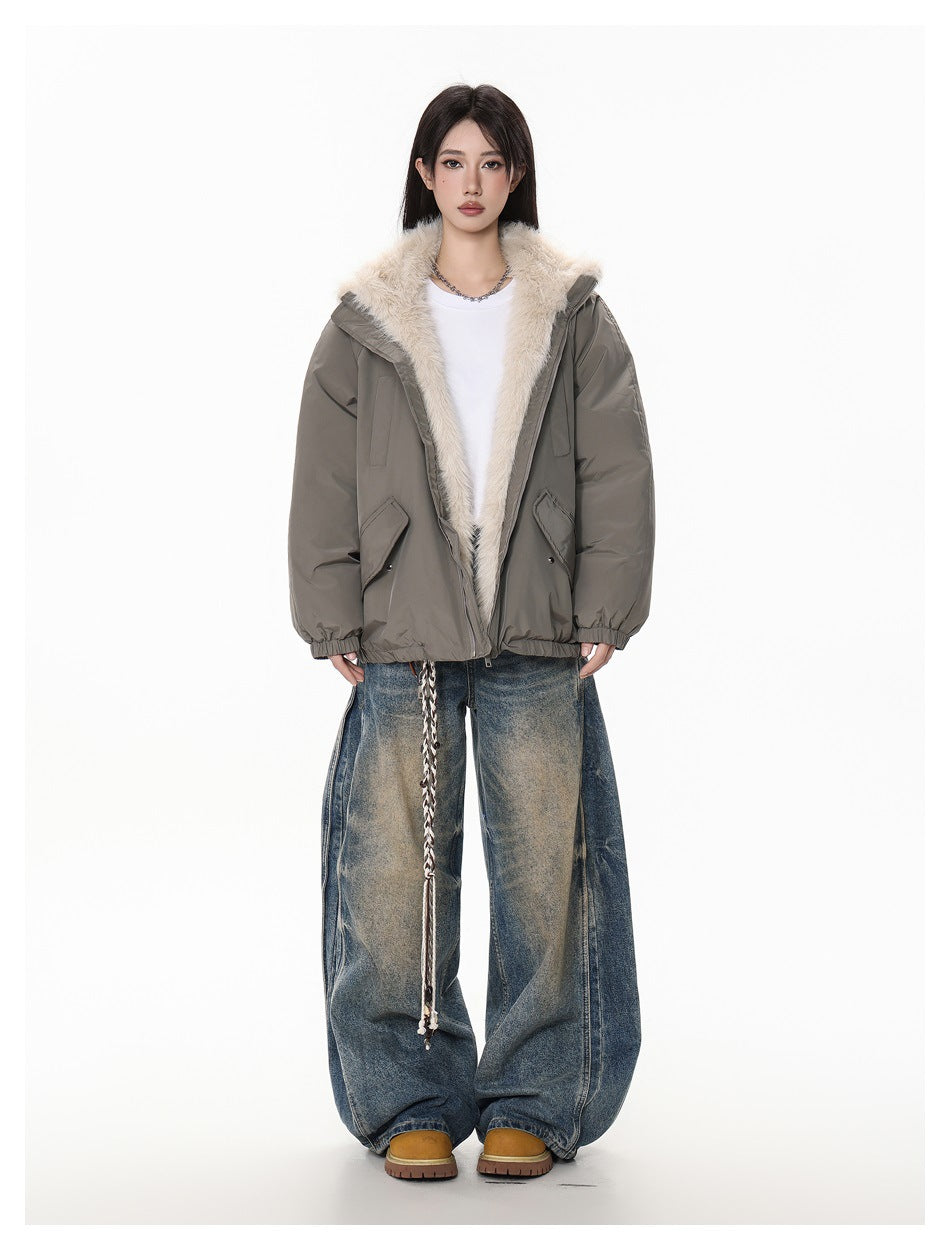 Model wearing the gray jacket open over a white tee and wide-leg jeans, showing cream fleece-like lining and flap pockets