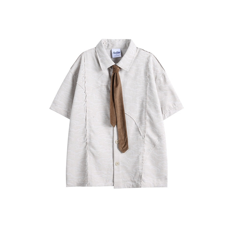 Gray short-sleeve button-up shirt with raw-edge seams, pointed collar and a brown tie, flat lay