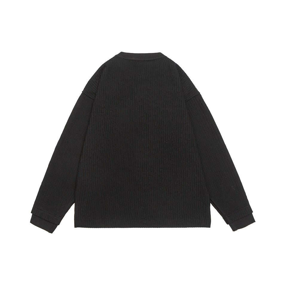 Back view of a black ribbed long-sleeve top with a round neckline and ribbed cuffs.