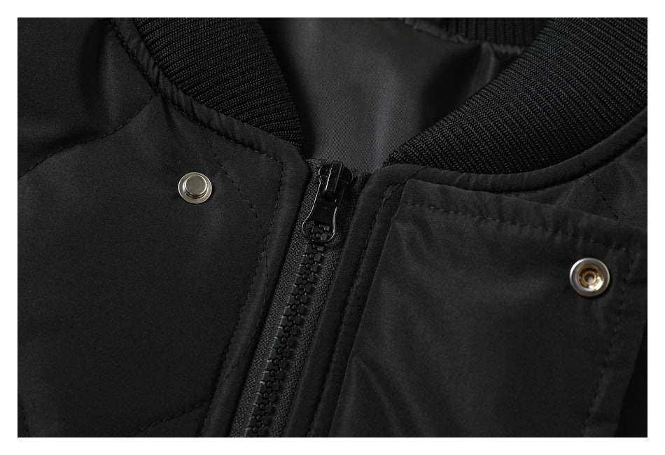 Close-up of the black jacket's ribbed collar, central zipper, and metal snaps.
