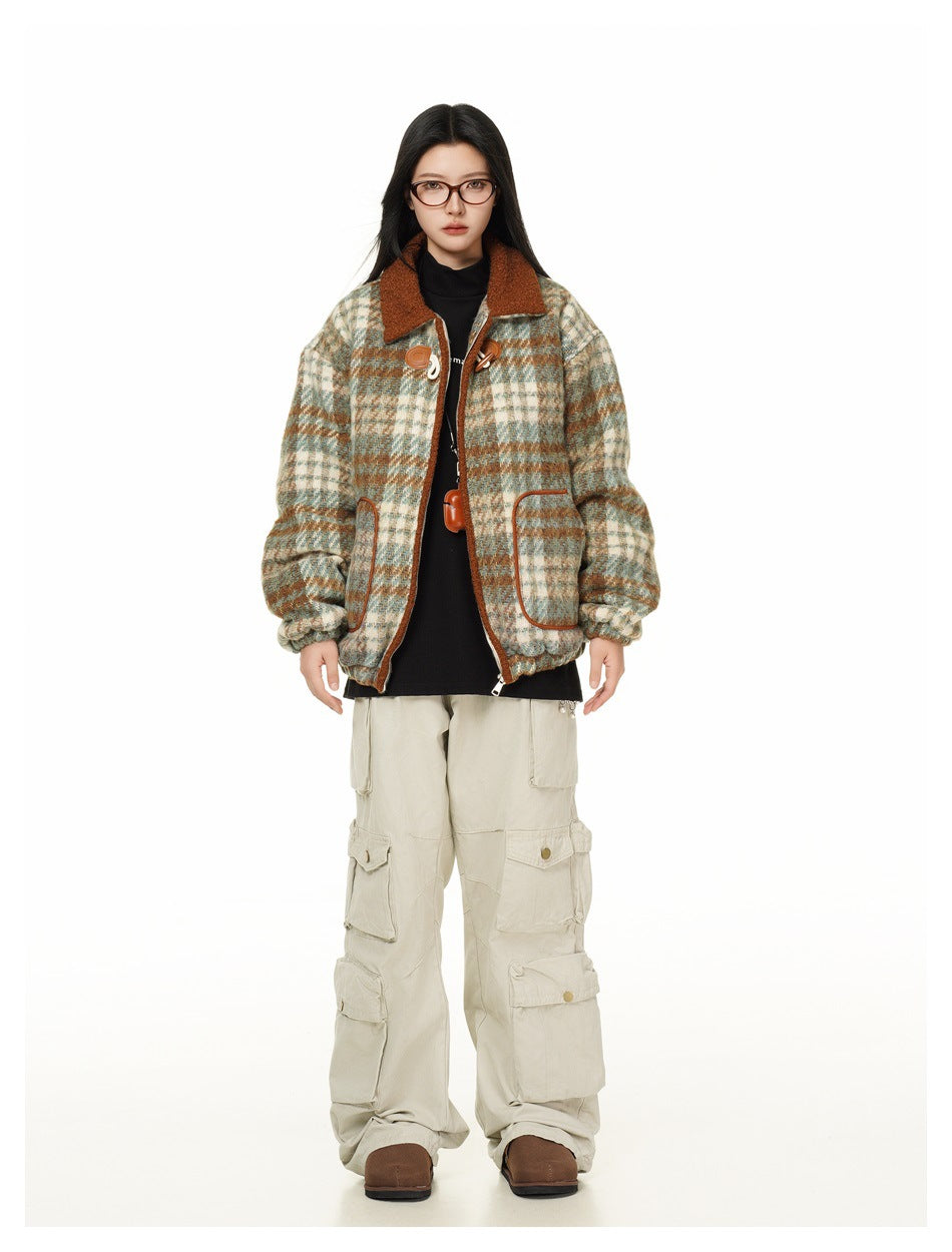Full-length front view of a model wearing an open cream, teal, and rust plaid jacket with a rust collar and toggle closures.