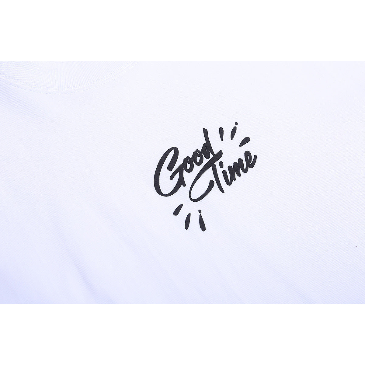 Close-up of a white T-shirt with black script reading “Good Time” on the chest.