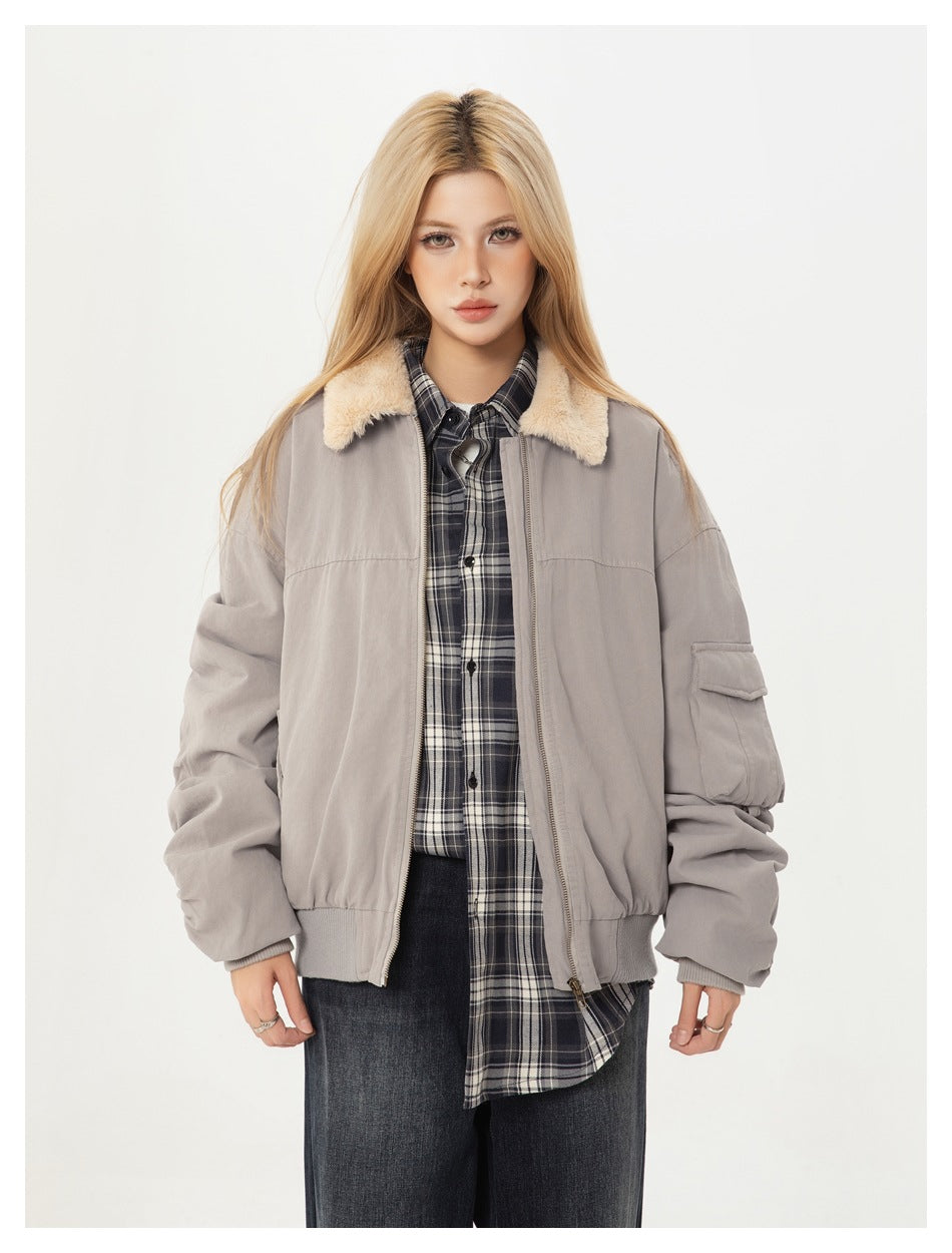 Model wearing a light gray bomber jacket with a cream sherpa collar, front view.