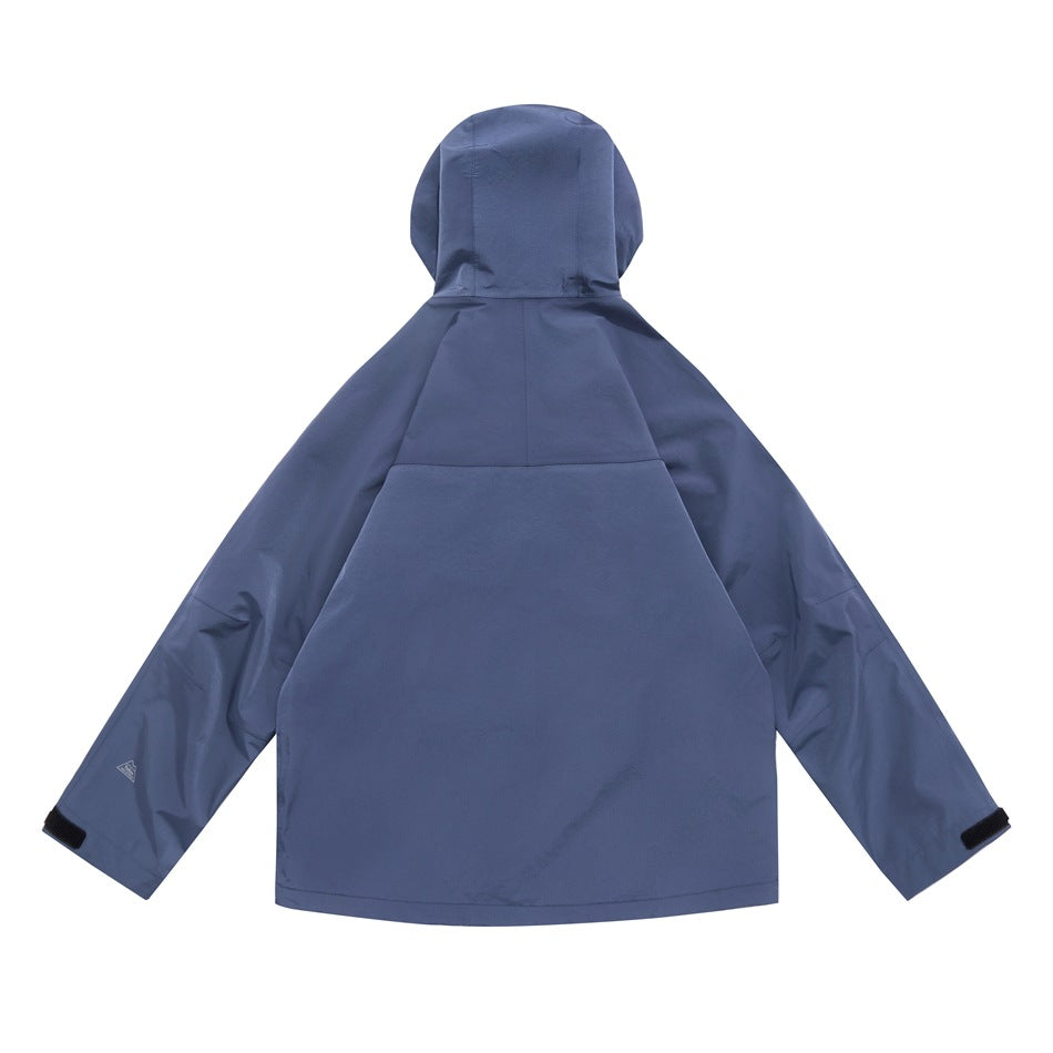 Back view of a blue hooded jacket with long sleeves, panel seams and adjustable cuffs.