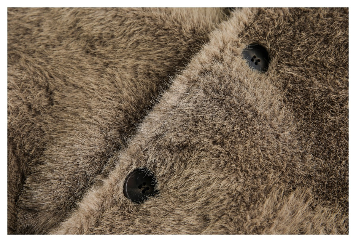 Close-up of two dark buttons on the brown faux-fur coat's front closure.