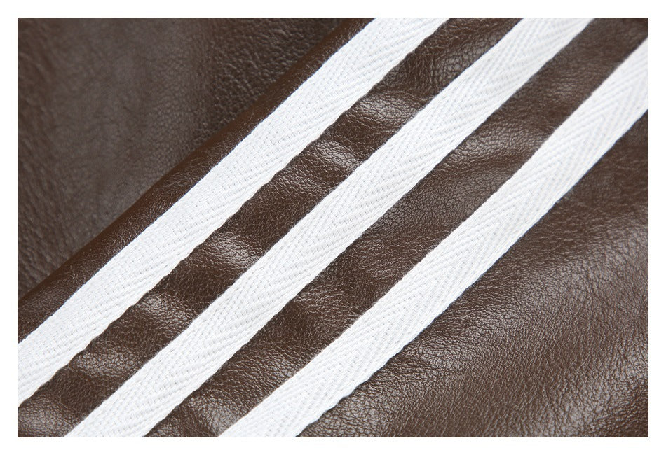 Close-up of three white stripes against the textured dark brown jacket surface.