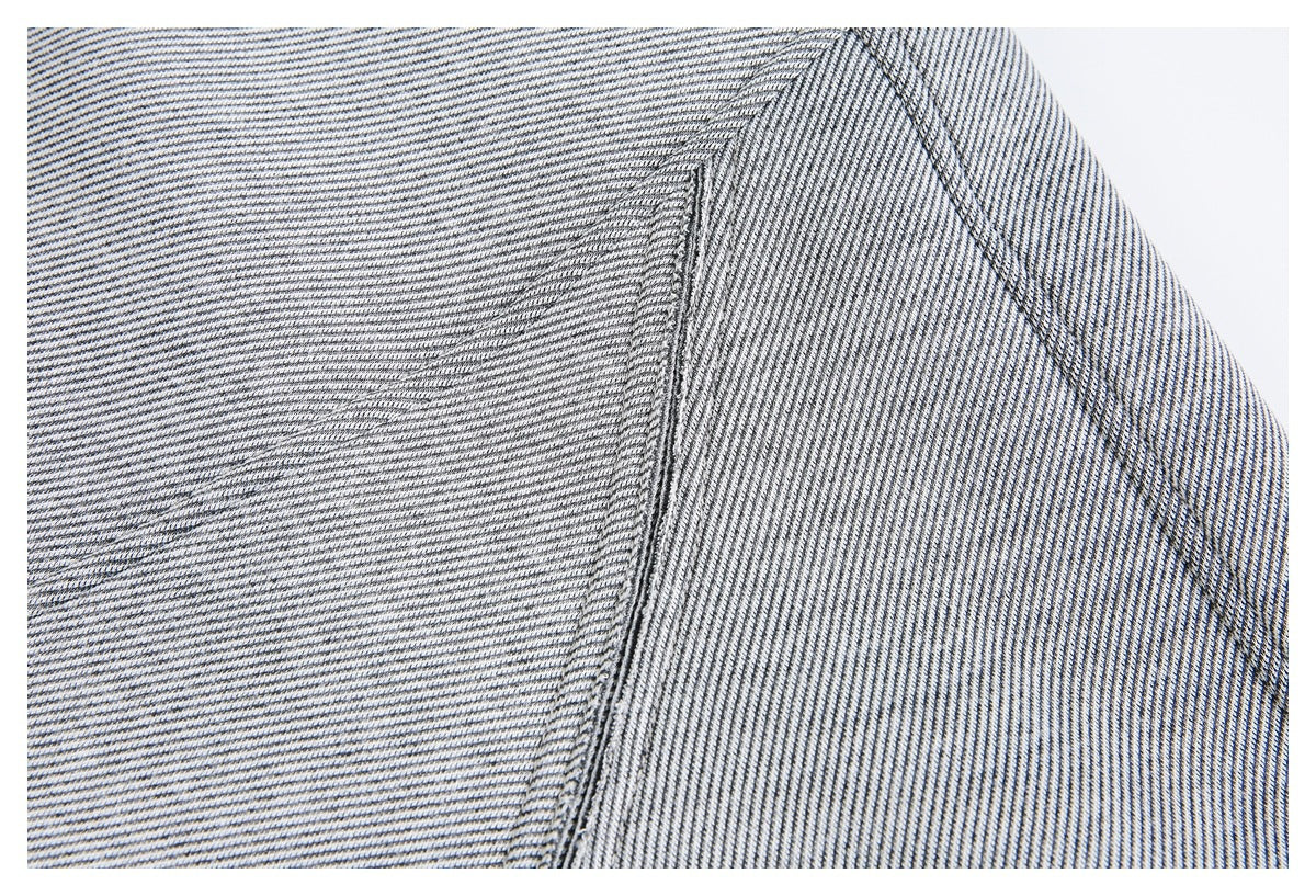 Close-up of the jacket's gray-and-dark diagonal stripe fabric and curved stitched seam.
