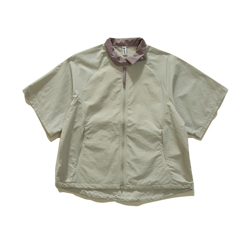 Sage gray-green short-sleeve zip jacket with mauve collar, raglan sleeves and side pockets, flat lay front view