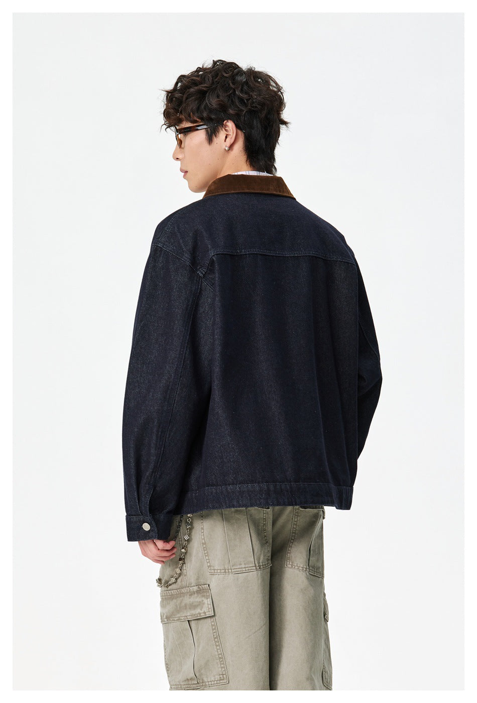 Model wearing the dark indigo jacket, shown from behind at an angle with its brown collar visible.