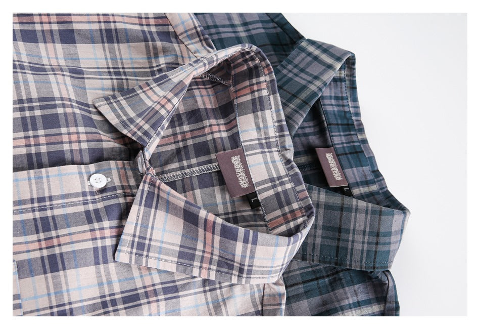 Close-up of two plaid shirt collars and inner labels in pale and dark colorways.