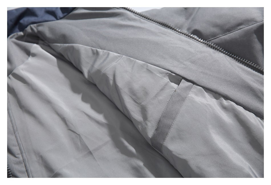 Close-up of the gray jacket interior, showing lining and a long zipper.