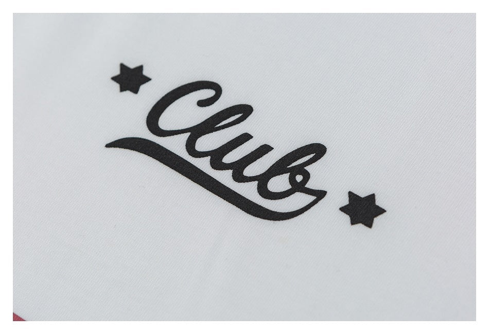 Close-up of a black script logo with two stars printed on white fabric.