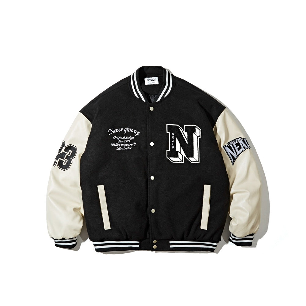 Front view of a black varsity jacket with cream sleeves, striped ribbing, snap buttons, and embroidered patches and