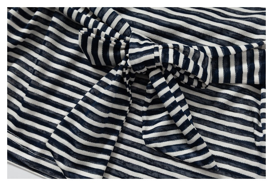 Close-up of a navy and cream striped garment with a matching fabric bow.