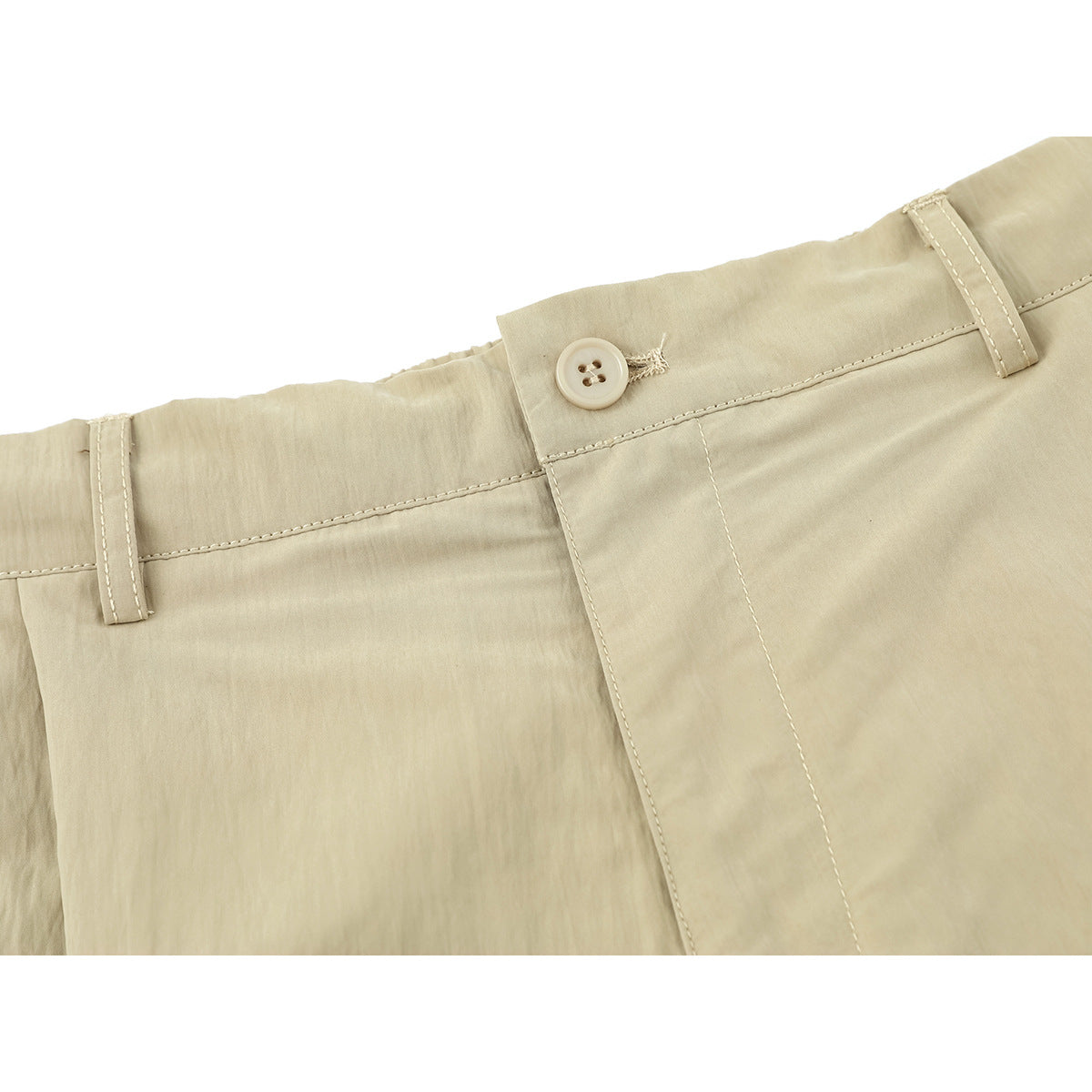 Close-up of beige trousers showing the waistband, belt loops, button, and fly stitching.