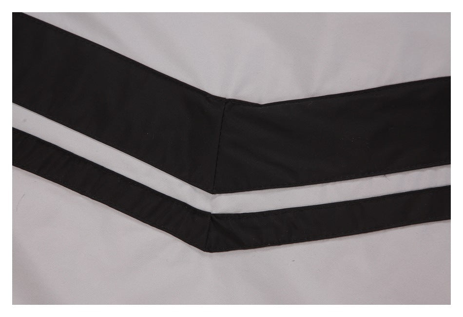 Close-up of black and light gray chevron-style bands on the jacket.