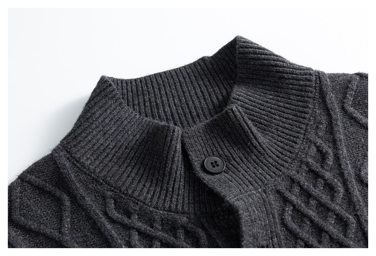 Close-up of a charcoal gray cable-knit cardigan collar with ribbed edging and a dark button.