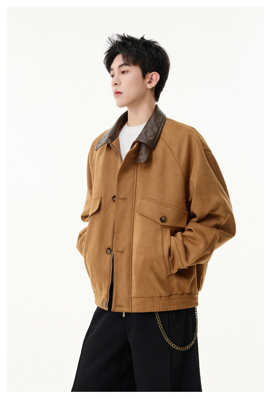 Side view of a model in a khaki boxy jacket with brown collar, flap pockets and elastic hem, one hand in pocket