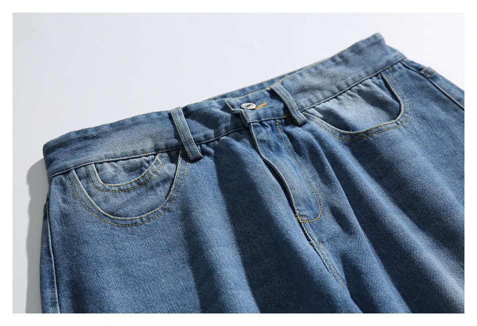 Close view of the jeans' front waistband, button, belt loops, fly and curved pockets.