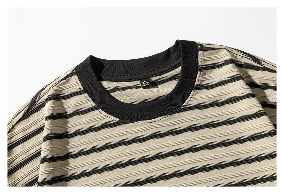 Close-up of the beige-and-black striped shirt's black crew neck and size label.