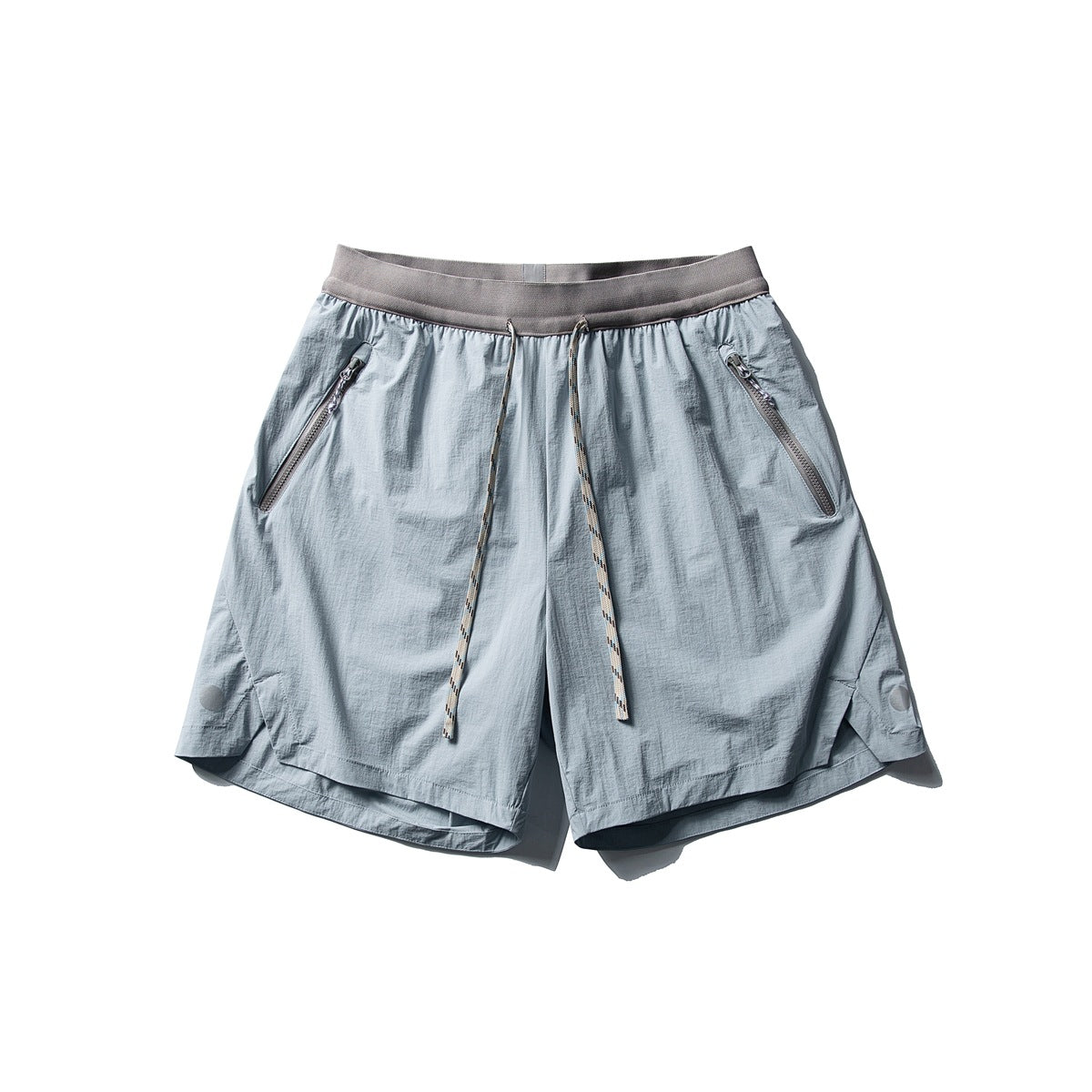 Glacier blue drawstring shorts with taupe waistband, zippered pockets and beige rope cord, flat lay