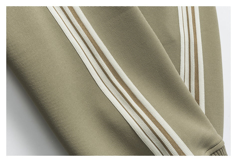 Close-up of cream and brown stripes running along an olive garment sleeve.