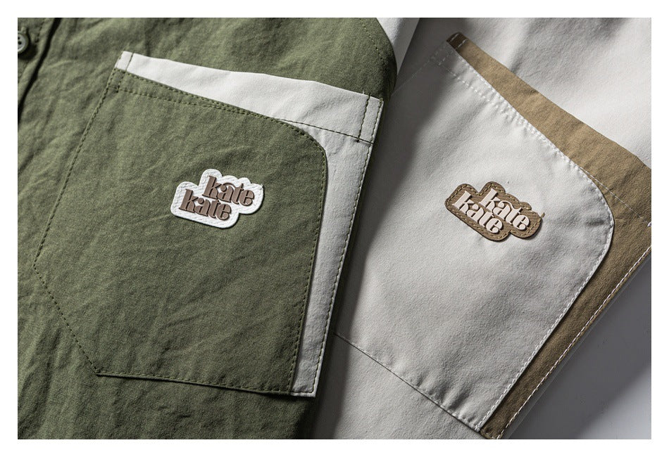 Close-up of olive and cream shirt chest pockets with contrasting trim and raised logo patches.