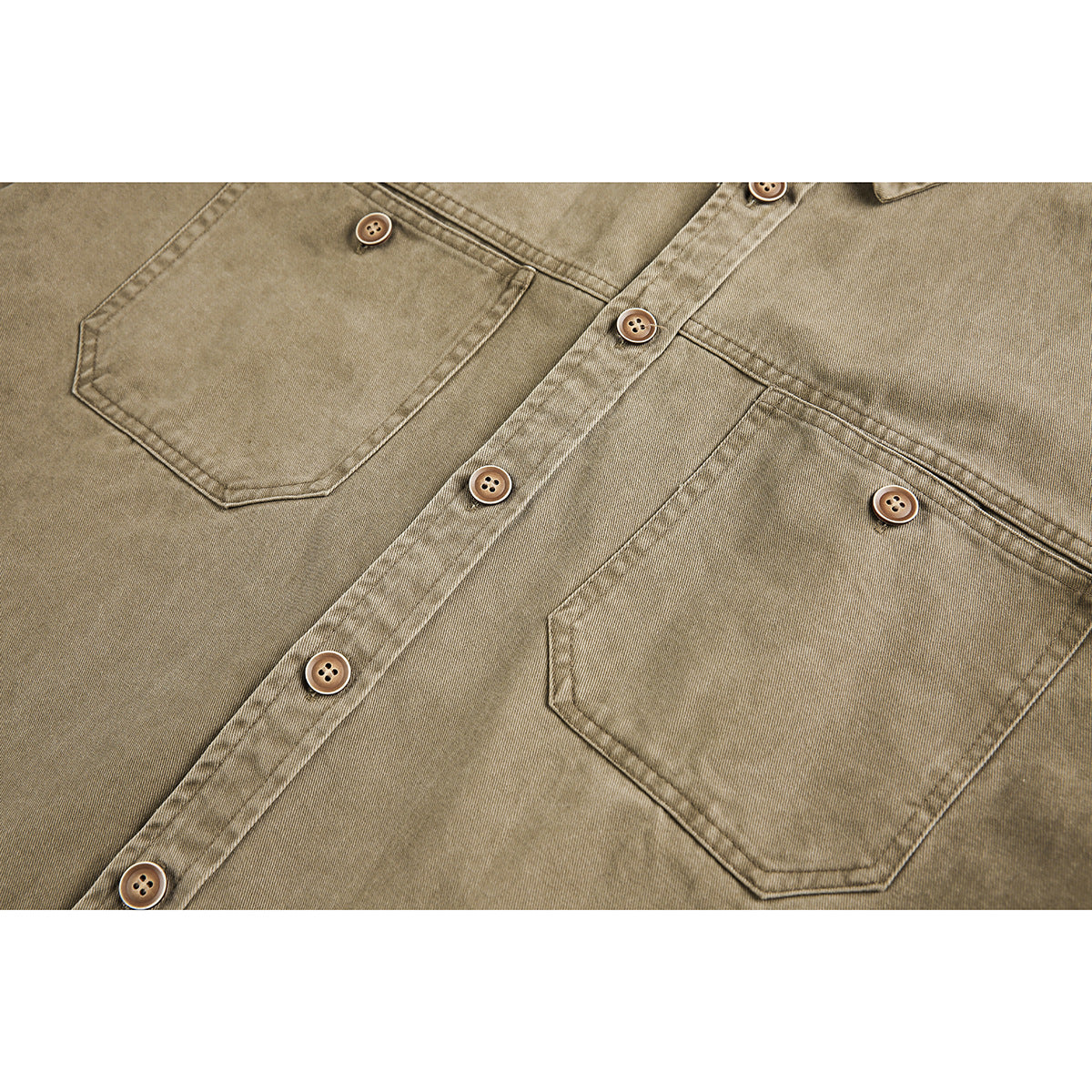 Close-up of a tan button-up shirt with two chest pockets, a button placket, and brown buttons.