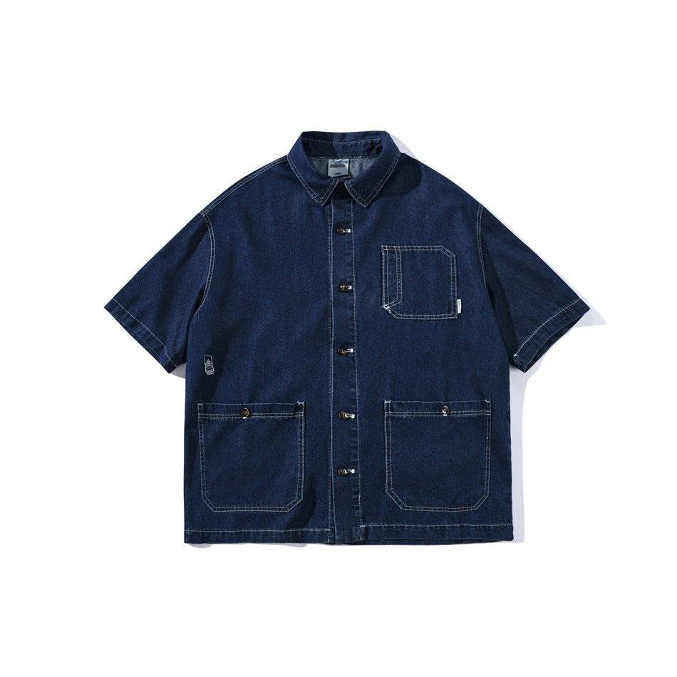 Dark blue short-sleeve denim-look button-up shirt with chest pocket and two large lower patch pockets, flat lay front view