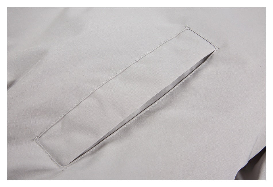 Close-up of a narrow welt pocket on the light gray jacket.
