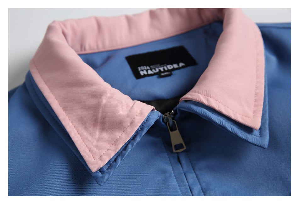 Close-up of the blue jacket's pink collar, zipper, and attached neck label.