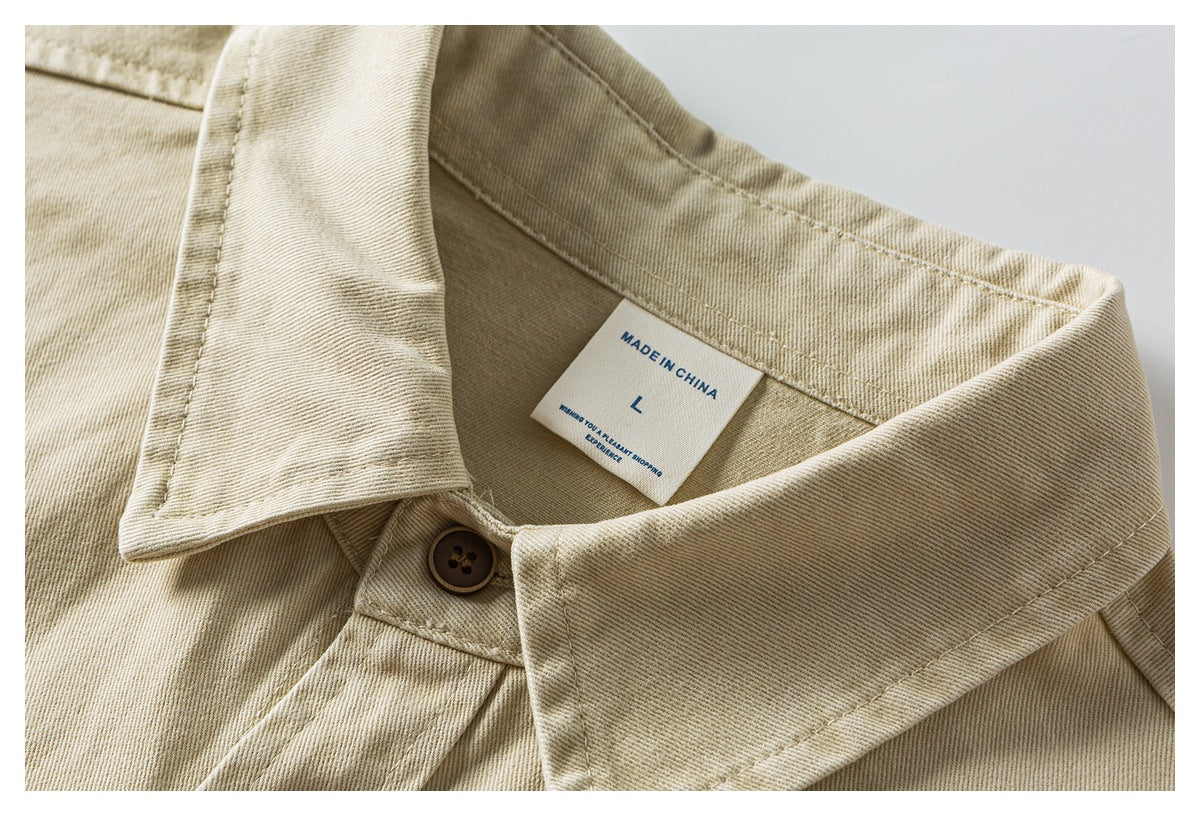 Close-up of a beige twill jacket collar, brown button, and inner label marked “MADE IN CHINA” and size L.