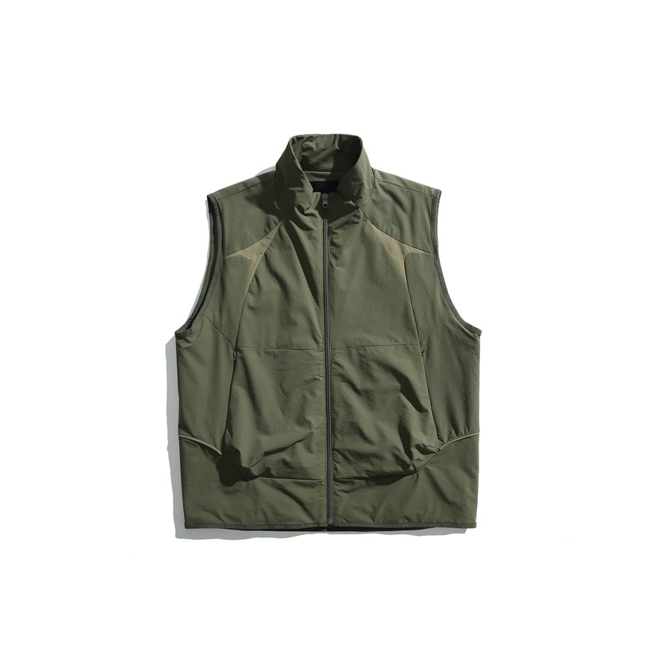 Olive green zip-front stand-collar vest with tan contrast shoulder panels, flat lay on white background