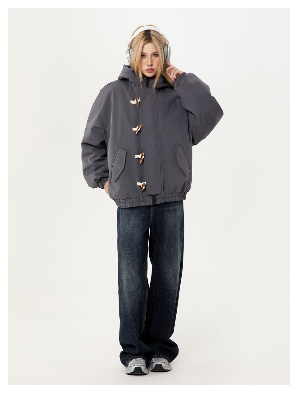 Model wearing the gray toggle hooded jacket fastened with wide-leg dark jeans, front view