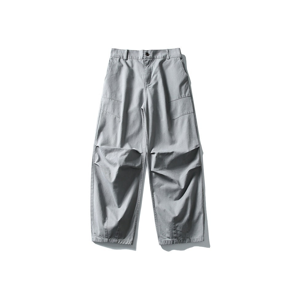 Gray wide-leg trousers flat lay front view with knee pleats and slanted thigh seams