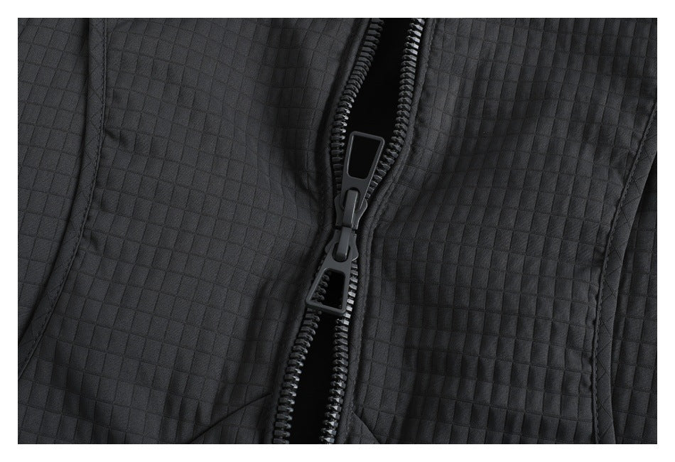 Close-up of the charcoal vest's front zipper and square quilted pattern.