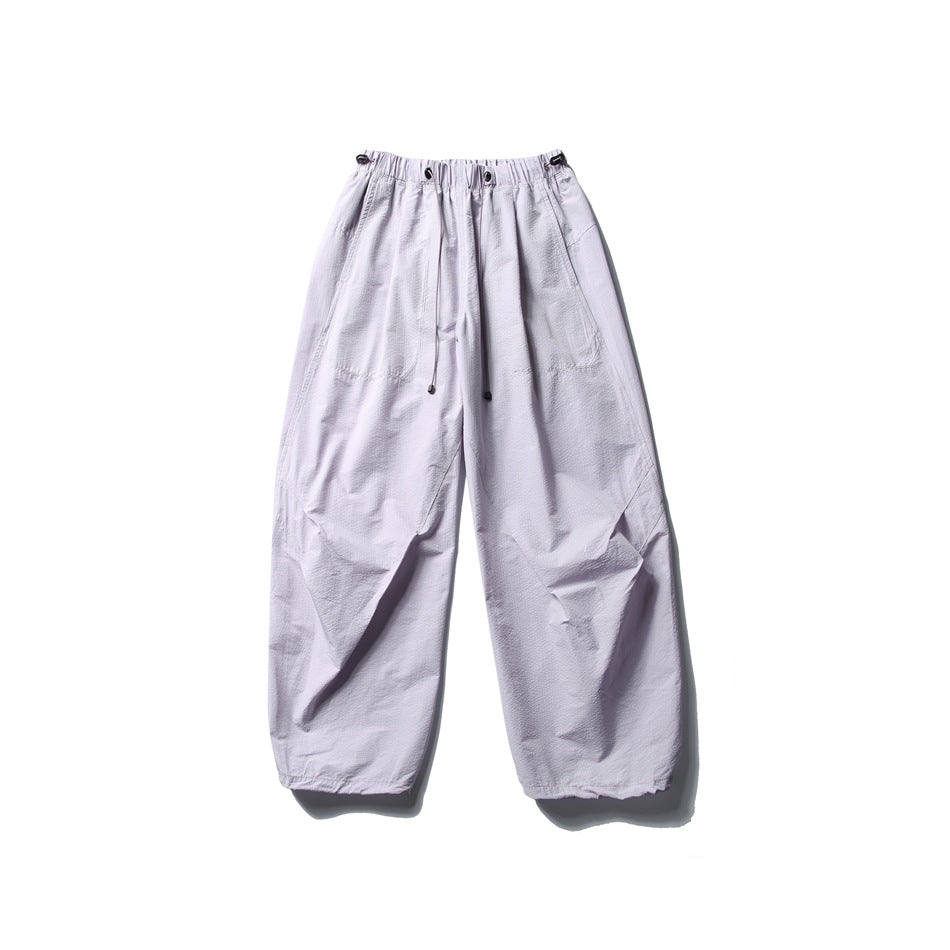 Pale lilac wide-leg parachute pants with drawcord elastic waistband, flat lay front view