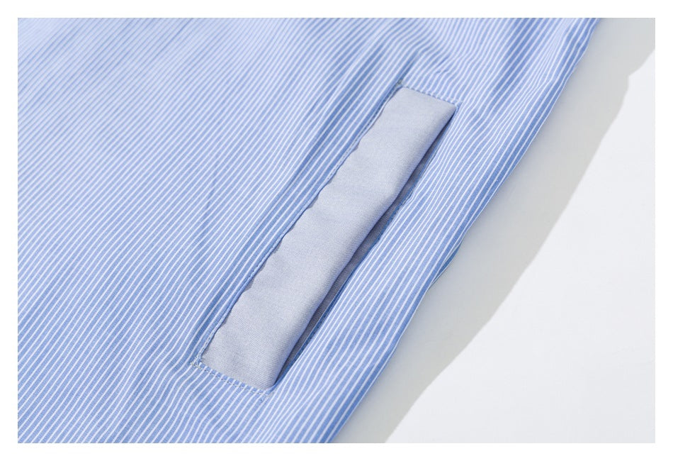 Close-up of a narrow solid-blue inset beside blue-and-white striped shirt fabric.