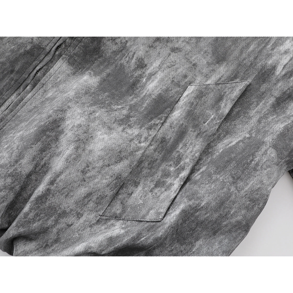 Close-up of a slanted welt pocket on a gray mottled jacket.