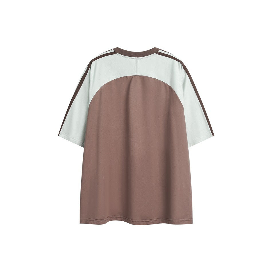 Back view of brown and pale sage color-block T-shirt with curved brown panel and striped sleeves