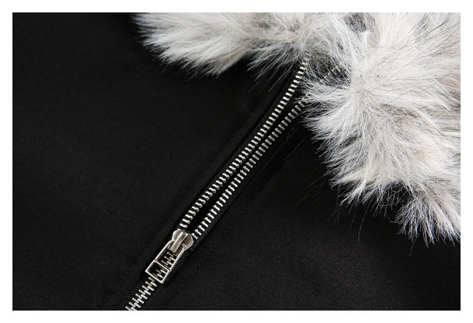 Close-up of the silver zipper and gray-white faux-fur trim on a black jacket.